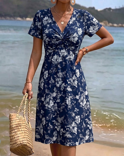 Mia — Robe fleurie avec décolleté en V et nœud twist
