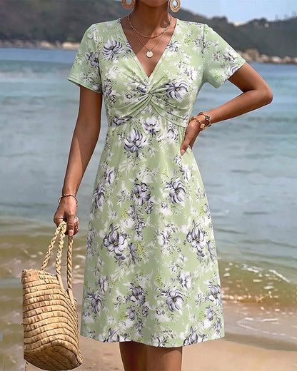 Mia — Robe fleurie avec décolleté en V et nœud twist